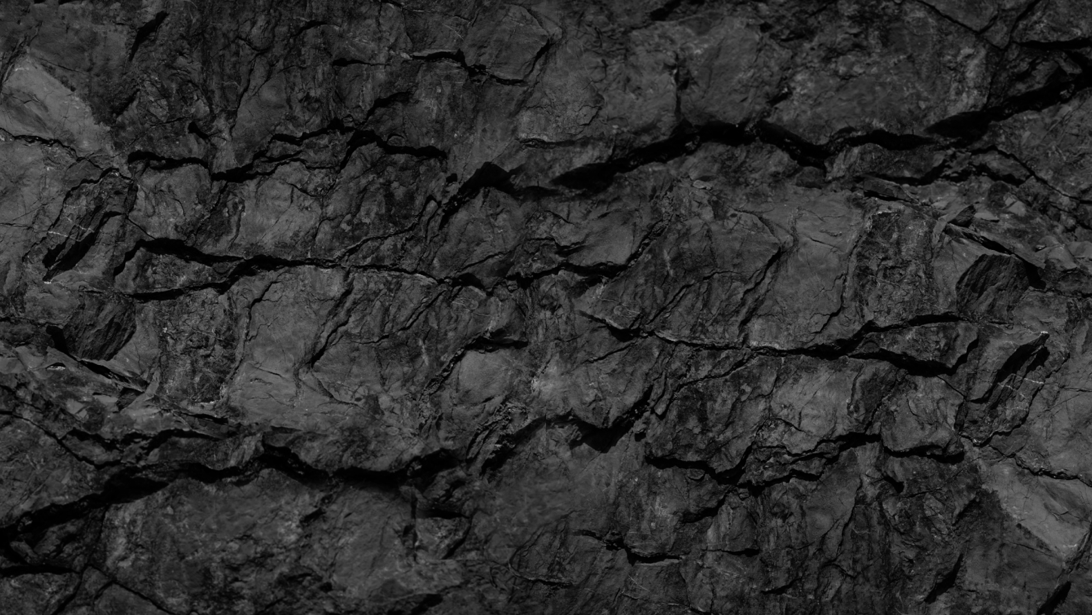 Aerial photography of shipping containers next to a rail road.