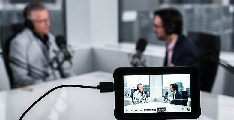 Photography of Paul Ricard's and Sean Ringstead's podcast on a camera screen preview.