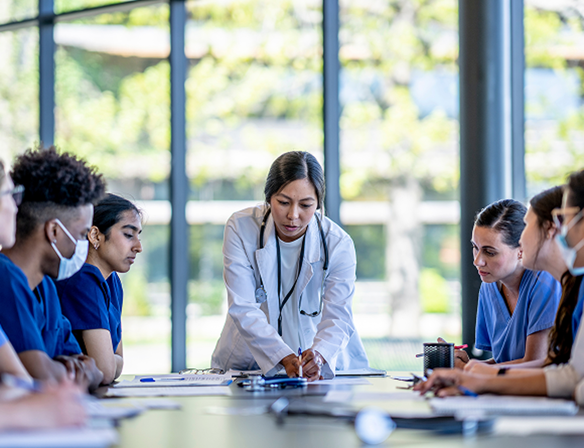 A group of doctors engaged in discussion while seated around a conference table, sharing ideas and insights.