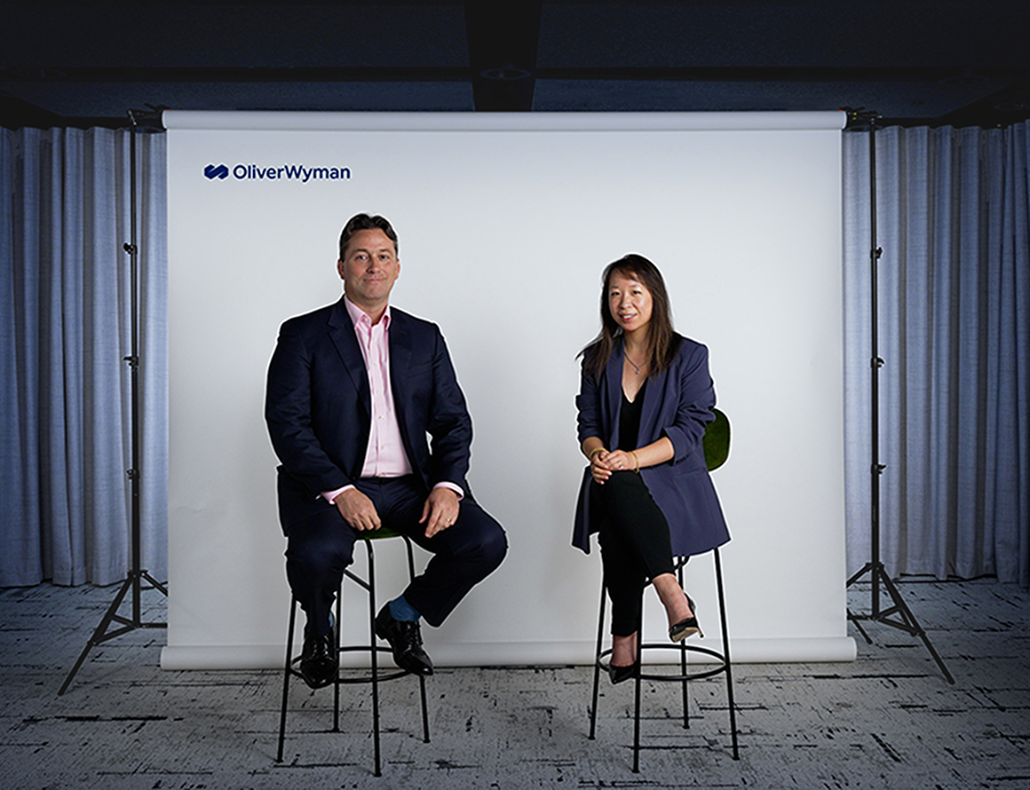 Oliver Wyman CEO, Nick Studer, and our Partner and UK and Ireland Social Impact Lead, Jennifer Tsim sitting next to each other.