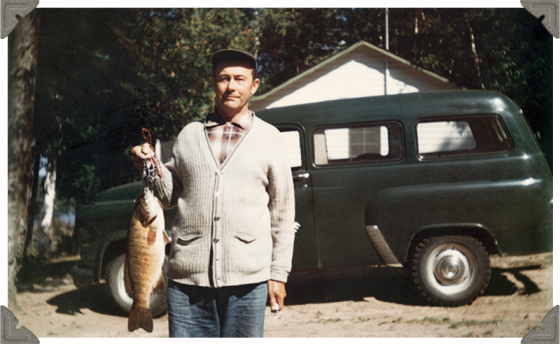 a picture of a man holding a fish he caught