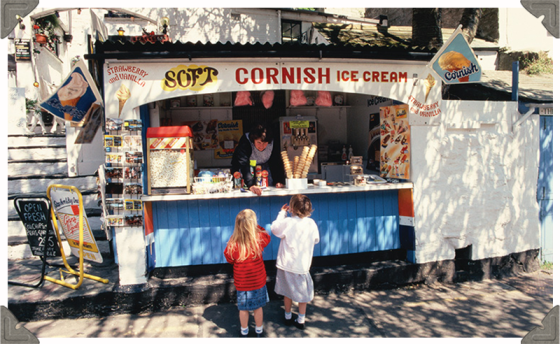 a picture of a lady selling ice cream to two children