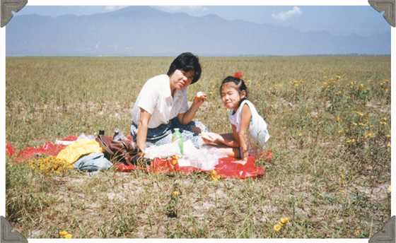 a picture of a woman and daughter having picnic