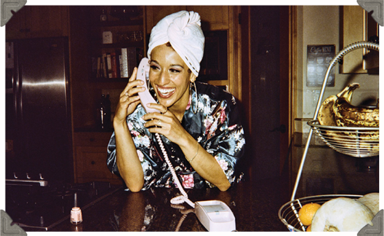 a picture of a woman talking on the phone happily