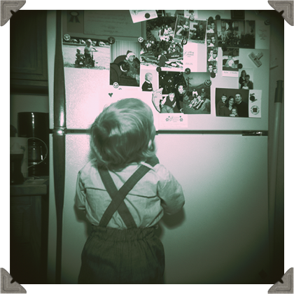 main cover picture of a boy looking at picture on fridge