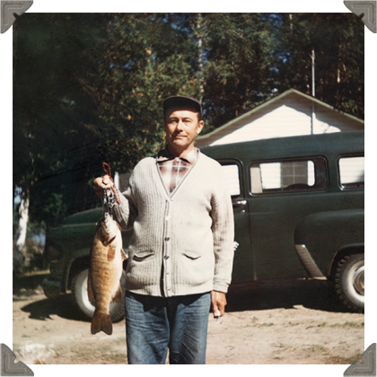 a picture of a man holding a fish he caught