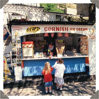 a picture of a lady selling ice cream to two children