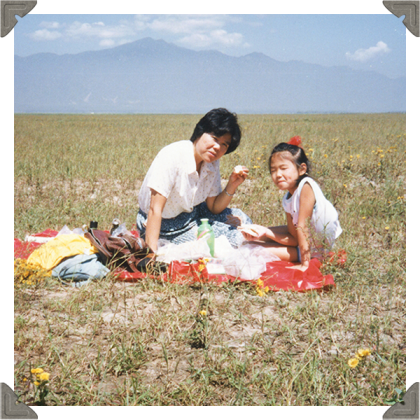 a picture of a woman and daughter having picnic