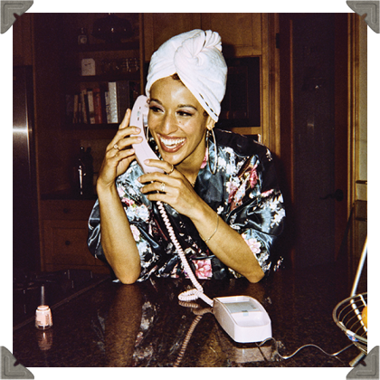 a picture of a woman talking on the phone happily