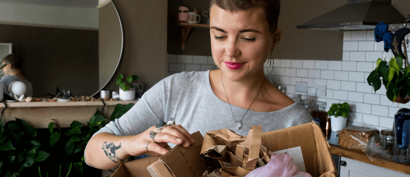 Young woman unpacks a package