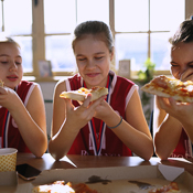 Team mates enjoying a pizza together