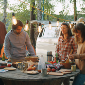 Friends sitting down to an outdoor dinner