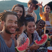 Friends taking a selfie with their fresh watermelon pieces